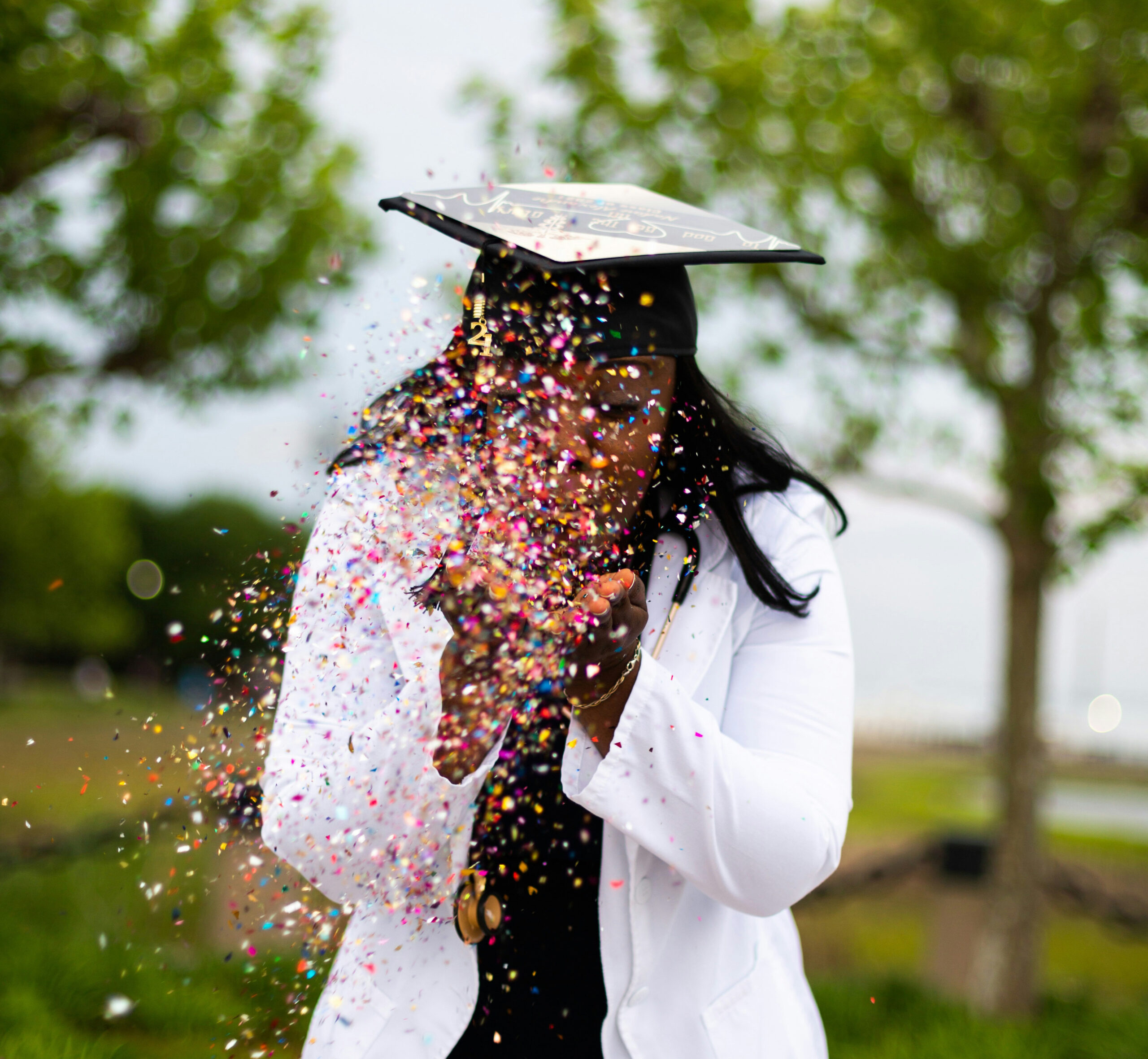 Graduate celebrating with confetti