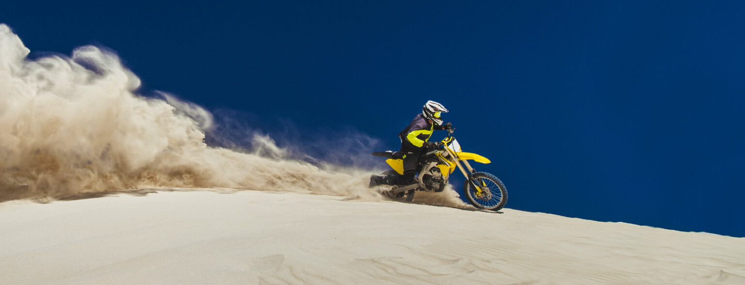 Motocross rider in sand dunes
