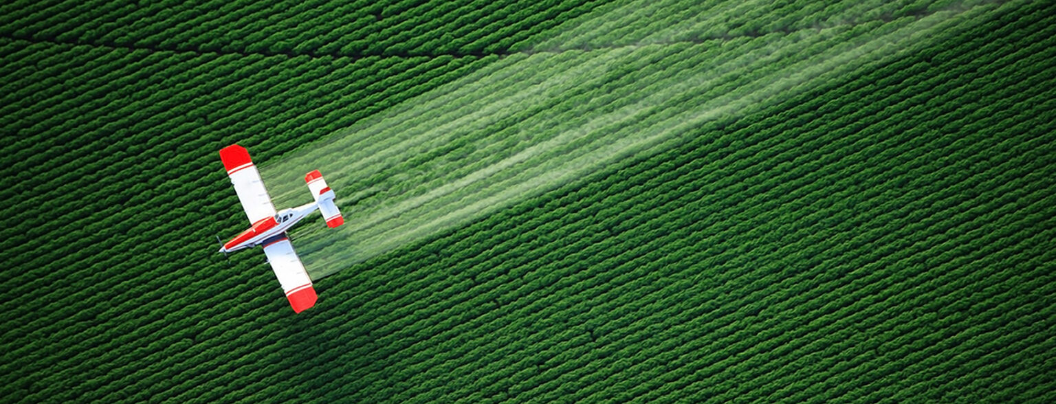 Red plane flying against green background